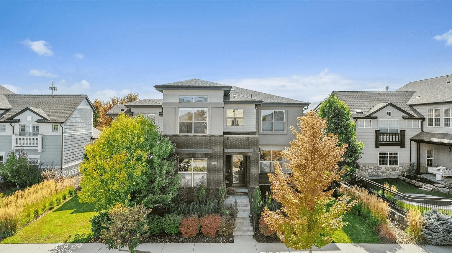 Modern two-story exterior with fall landscaping