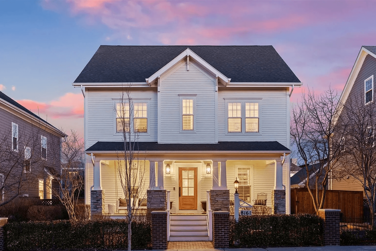 Twilight exterior — white colonial at dusk